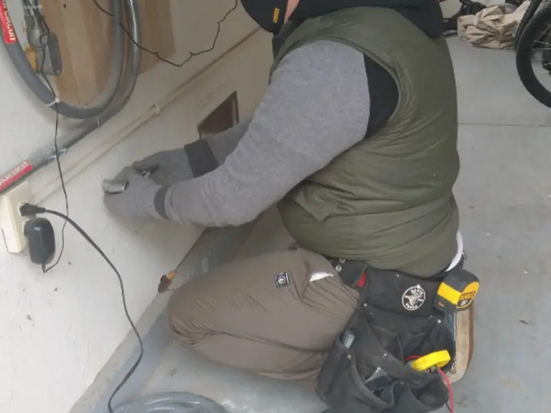 Electrician performing outlet wiring in a North Cornwall garage