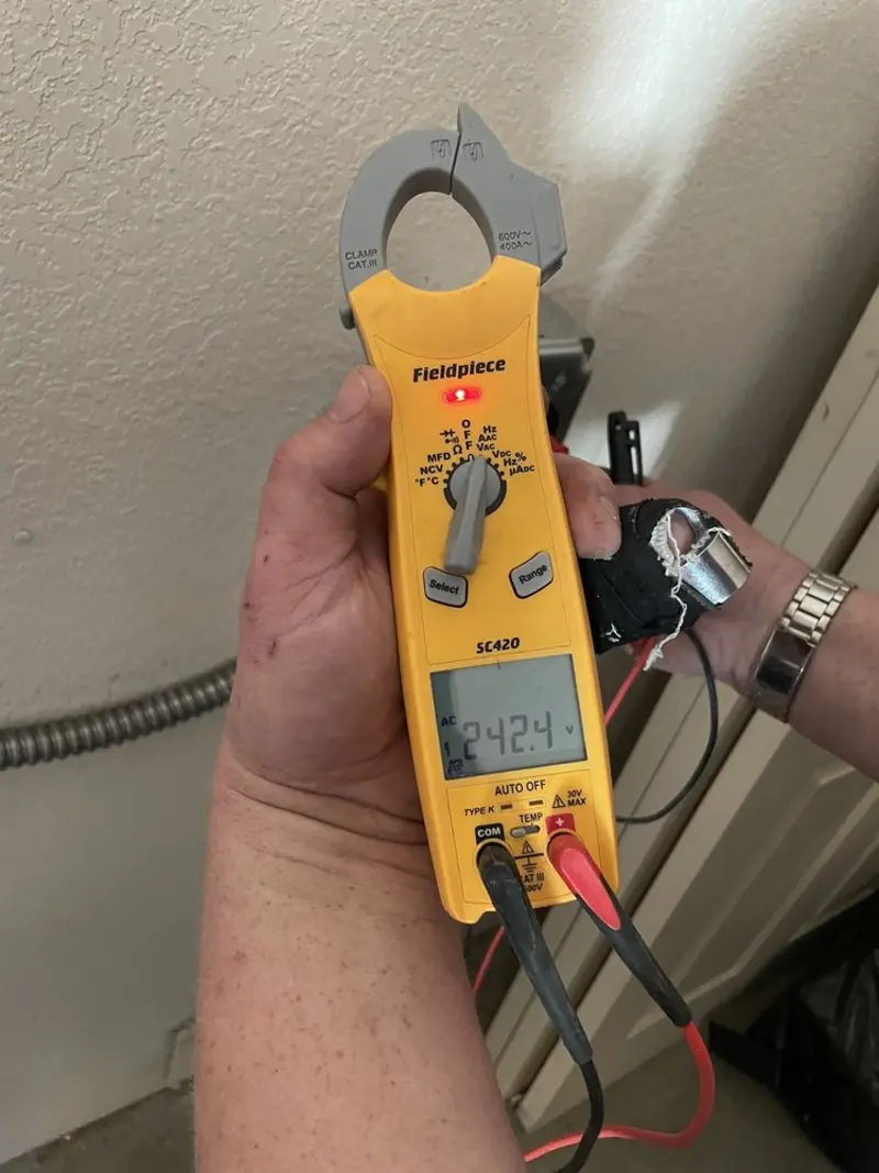 Voltage testing with clamp meter during Ceiling Fan Installation in North Cornwall